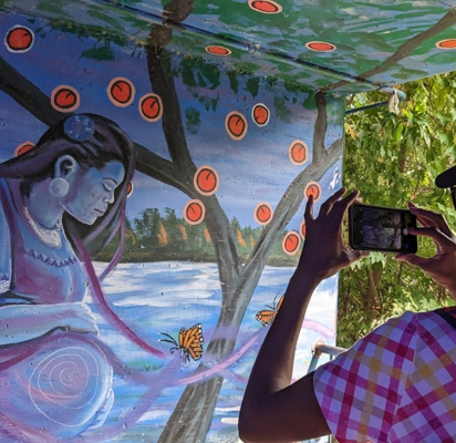 Female taking a picture of a mural